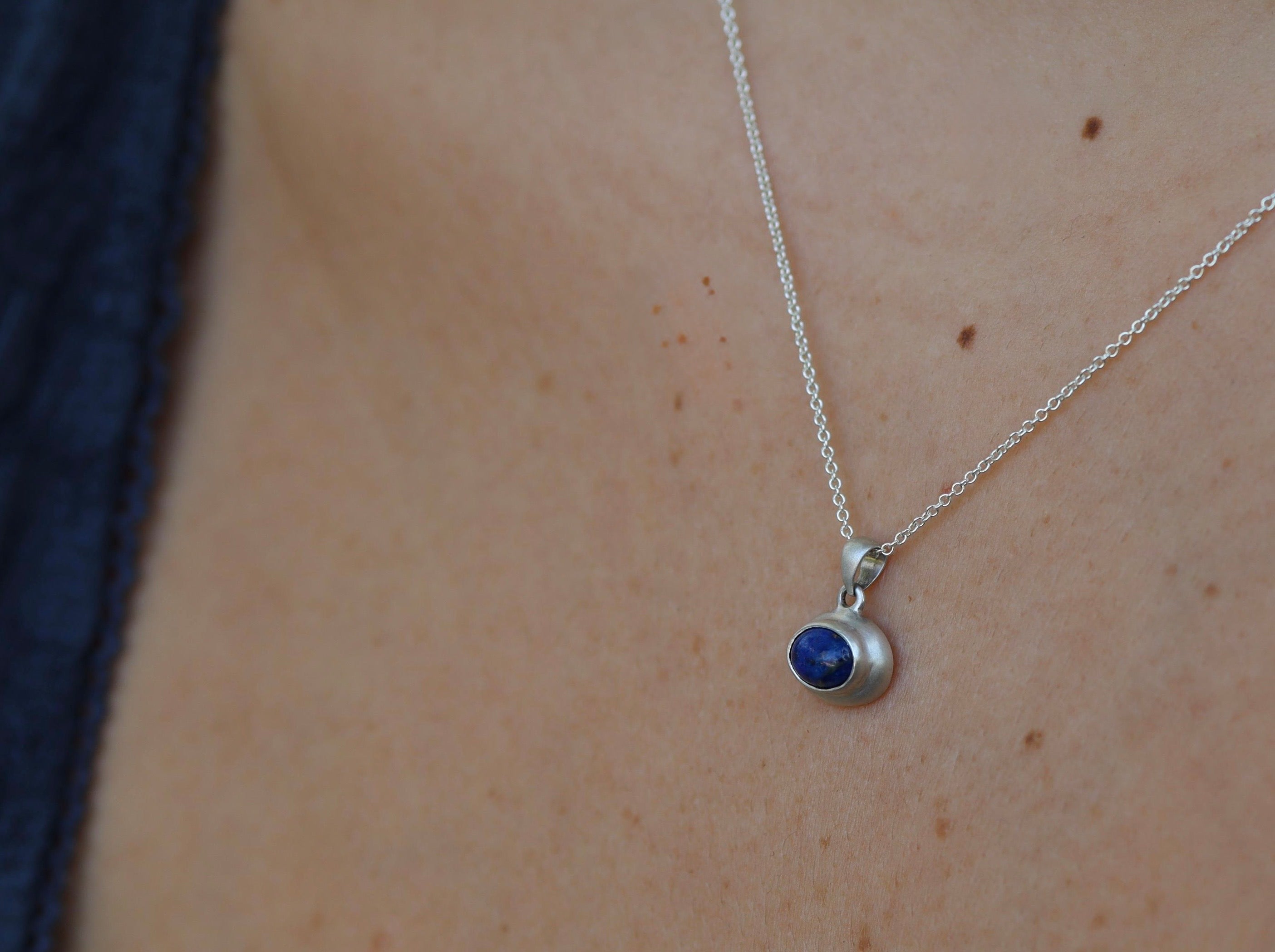Lapis lazuli sterling silver pendant worn on neck