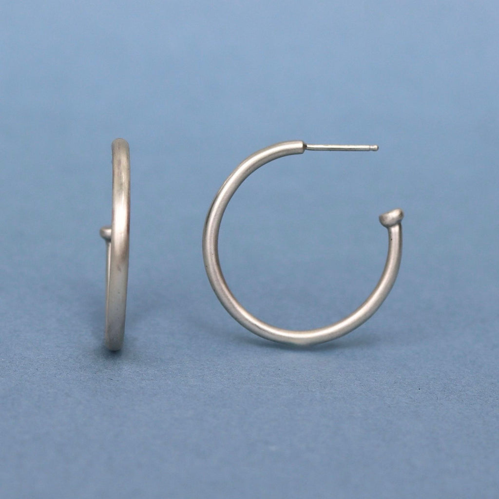 Classic sterling silver hoop earrings handcrafted in solid sterling silver with a minimalist design.