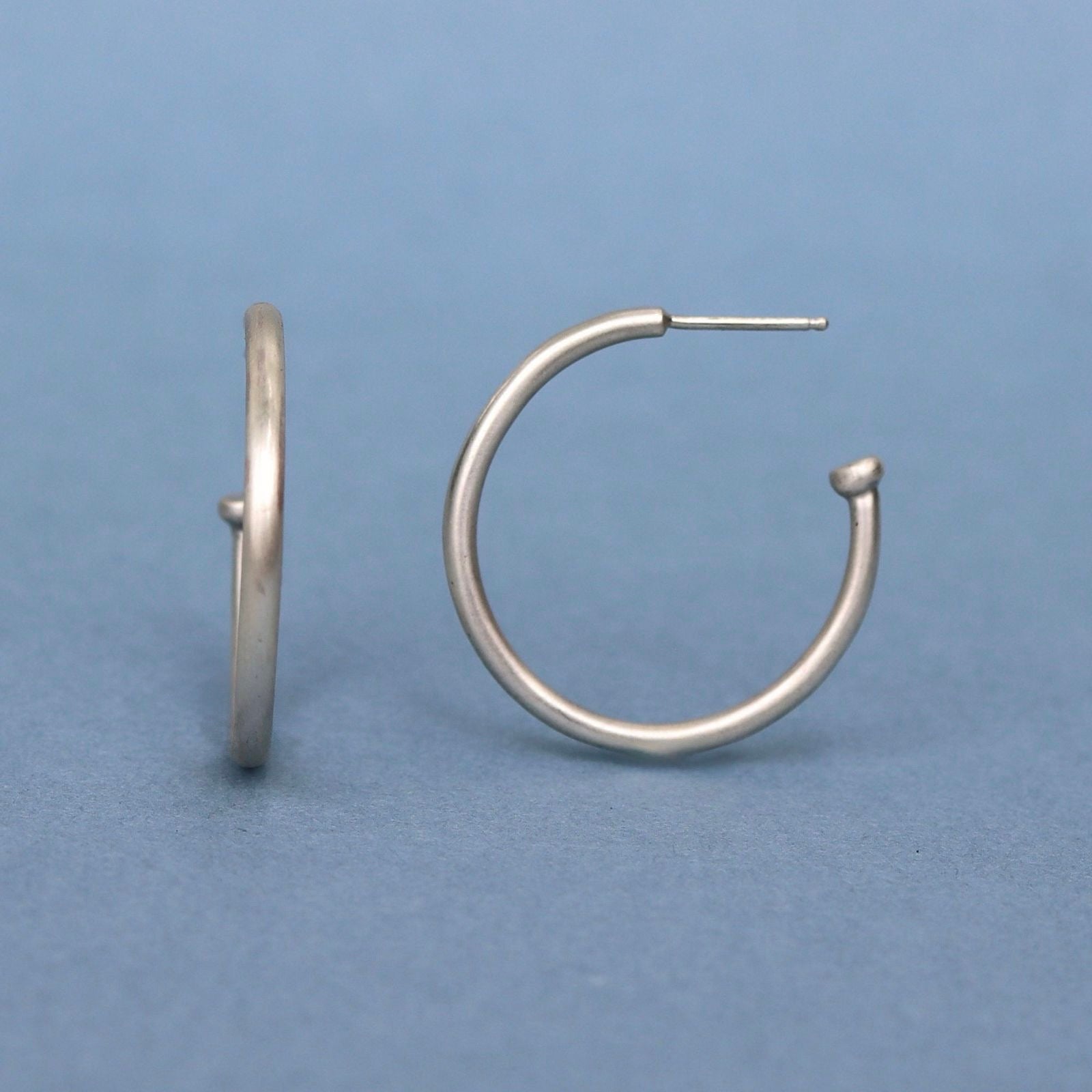 Classic sterling silver hoop earrings handcrafted in solid sterling silver with a minimalist design.