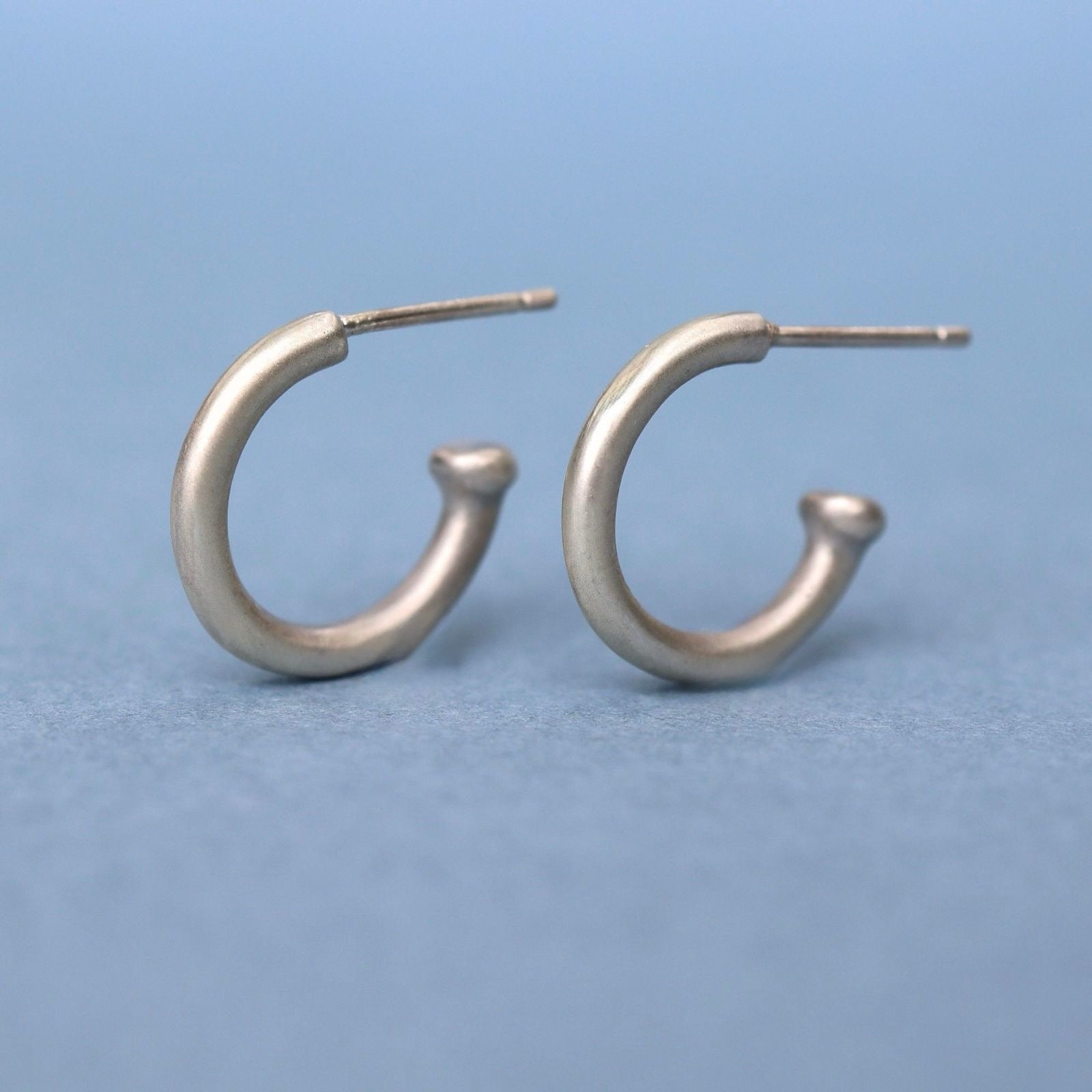 Handcrafted sterling silver huggie hoop earrings with a timeless minimalist design. Lightweight, comfortable, and made for everyday wear.