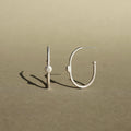 Sterling silver hoop earrings with natural diamond accents and a minimalist design.