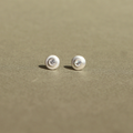 Handcrafted sterling silver stud earrings featuring natural diamonds.