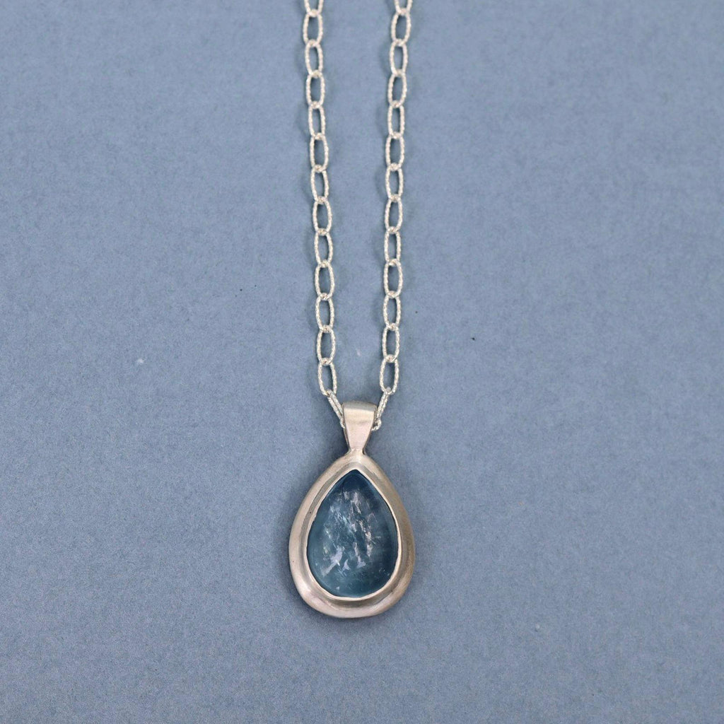 Handcrafted sterling silver pendant featuring a natural aquamarine cabochon on a sterling silver chain.