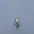 Handcrafted sterling silver pendant featuring a natural aquamarine cabochon on a sterling silver chain.