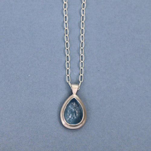 Handcrafted sterling silver pendant featuring a natural aquamarine cabochon on a sterling silver chain.