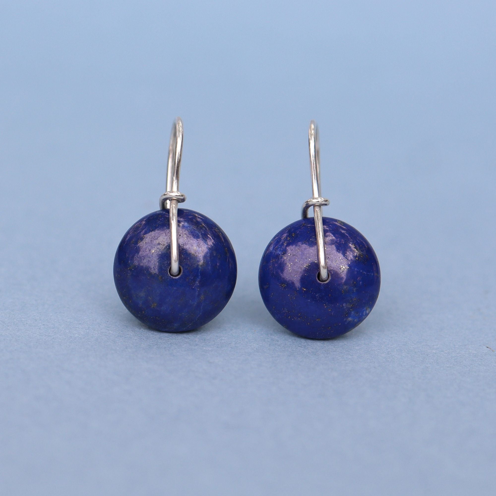 Handcrafted sterling silver drop earrings featuring natural lapis beads.