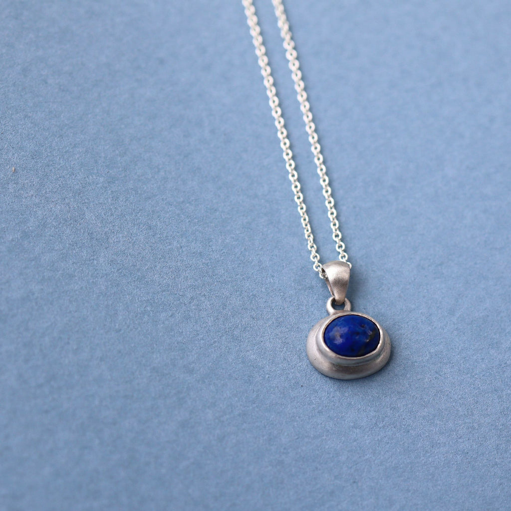 Natural lapis lazuli cabochon set in sterling silver pendant