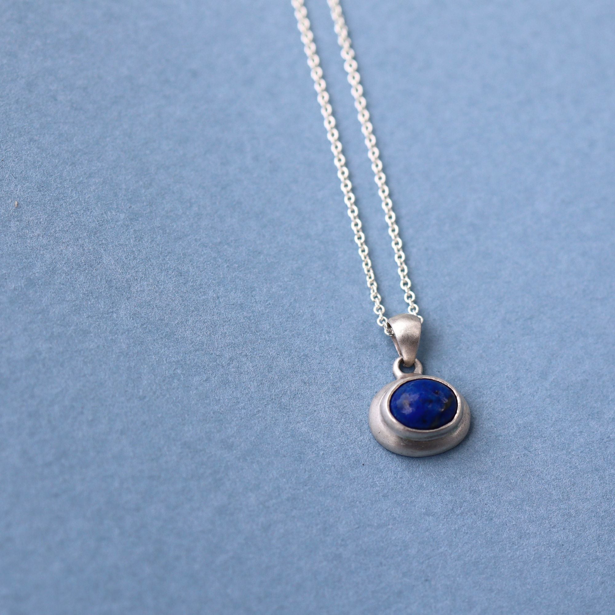 Natural lapis lazuli cabochon set in sterling silver pendant