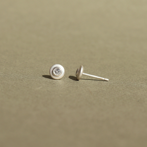 Handcrafted sterling silver stud earrings featuring natural diamonds.