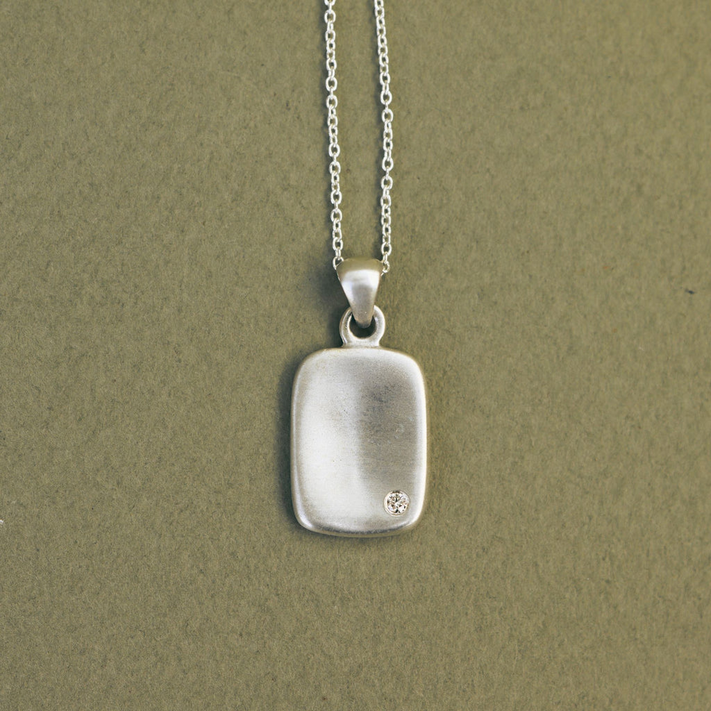 Handcrafted sterling silver Memory Tag pendant featuring a natural diamond. 