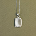 Handcrafted sterling silver Memory Tag pendant featuring a natural diamond. 