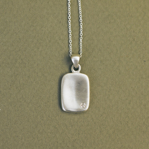 Handcrafted sterling silver Memory Tag pendant featuring a natural diamond. 